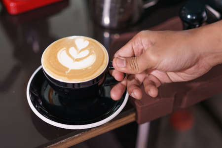 Hand holding cup of coffee.の写真素材
