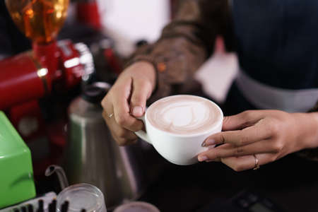 Hand holding coffee background.の写真素材