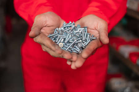 image of mechanical hands with lots of boltsの写真素材