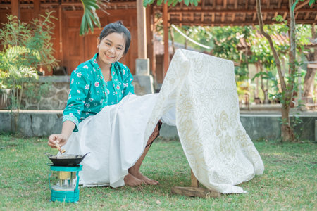 portrait young woman drawing batik in the gardenの写真素材