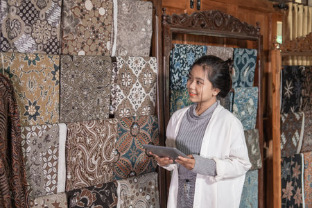 women checking stock traditional batik cloth and clothes