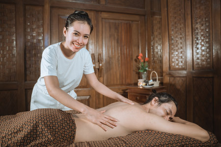 Therapist doing a body massageの写真素材