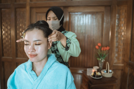 professional therapist giving massageの写真素材