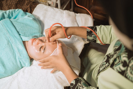 Young woman feel relax having facial treatmentの写真素材