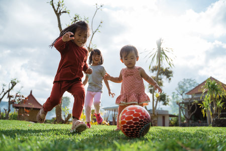 Little girl enjoyed playing ball together in the backyardの写真素材