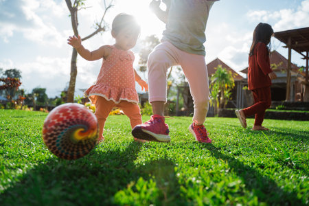 Little girl enjoyed playing ball together in the backyardの写真素材
