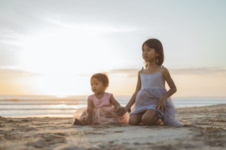 little sisters at the beach