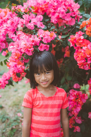 little girl pictured against bougenvilleの写真素材