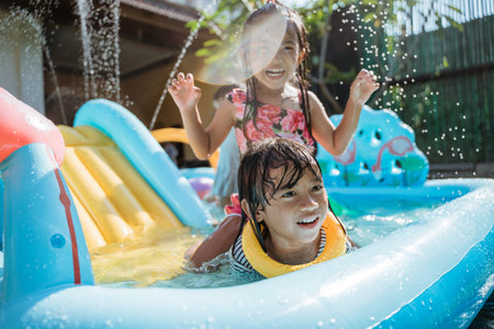 children very happy playing water slideの写真素材