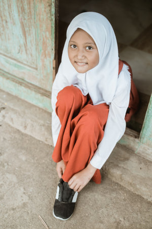 indonesian primary school student getting ready to school in the morningの写真素材