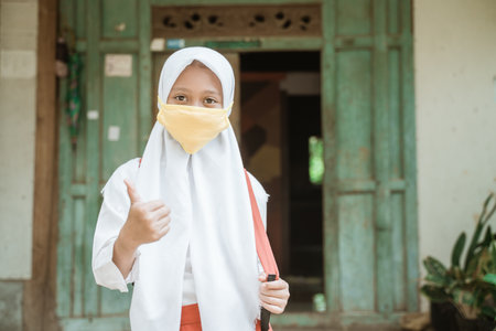 indonesian asian primary student wearing a masksの写真素材