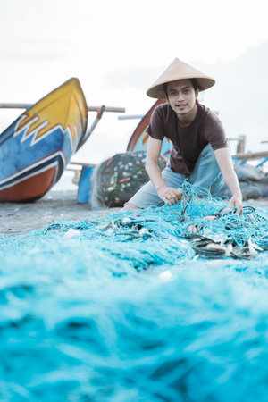 Portrait of a young male fishermanの写真素材