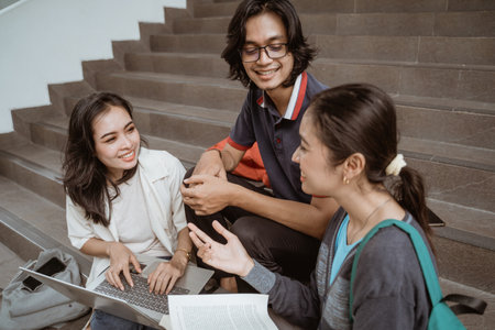 Portrait students sit down working in groupsの写真素材