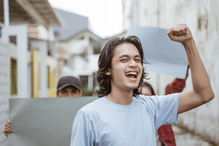Portrait male students holding blank paper who are burning with enthusiasm