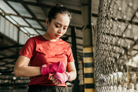 portrait of boxer fighter applying bondage tapeの写真素材