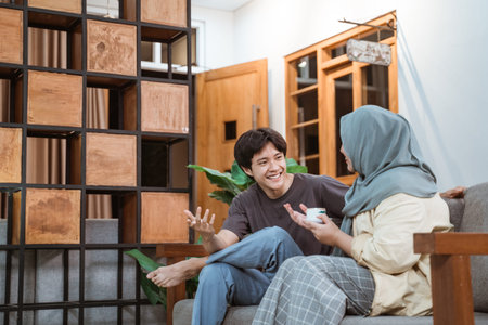 muslim young couple chatting on sofaの写真素材