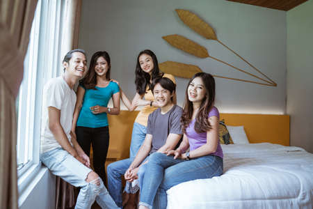 five asian young friend having fun together in the bedroomの写真素材