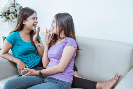 young adult asian twin sister togetherの写真素材