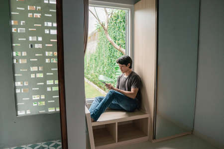 asian man designer working home using laptop at homeの写真素材