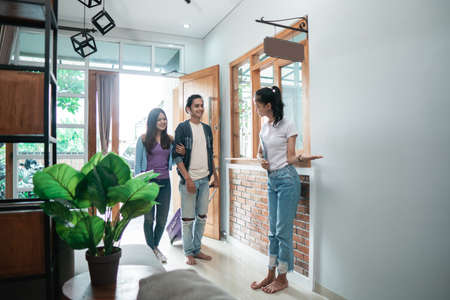 guesthouse staff welcoming couple in boutique hotelの写真素材