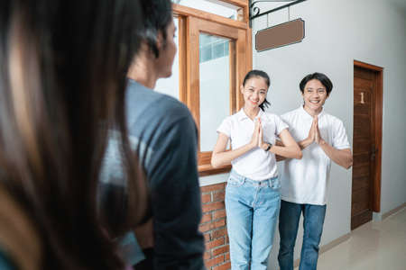guesthouse staff welcoming couple in boutique hotelの写真素材