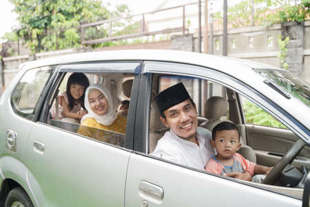 Muslim family travel by car during eid mubarak celebrationの写真素材