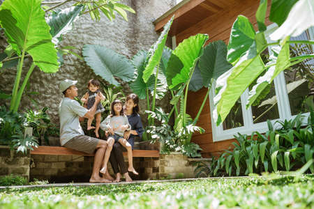 A family enjoy their time at tropical backyard at homeの写真素材