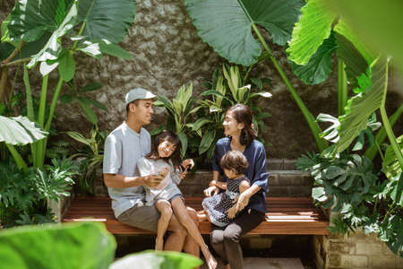 A family enjoy their time at tropical backyard at homeの写真素材