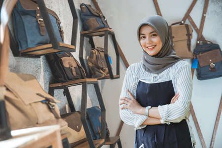 asian muslim business owner in a bag shop with tabletの写真素材
