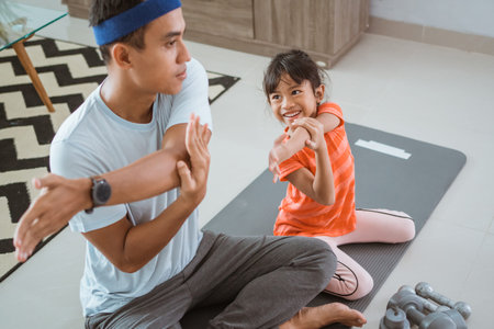 father and daugther exercising together at home