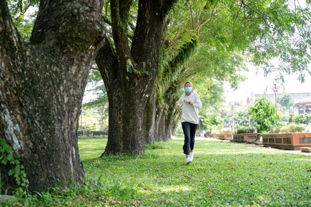 muslim woman doing sport and using mask outdoor to prevent virus spreading