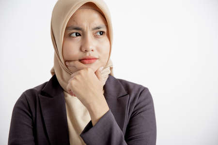 close up young businesswoman smiling try understand expression office work concept isolated white backgroundの写真素材