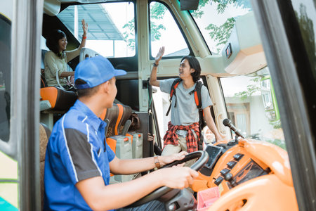 a male passenger boarded the bus with a waving hand when he met his group of friends on board the...