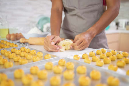 close up of hand making dough for nastar cake during eid mubarakの写真素材