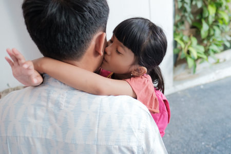 portrait of asian father embrace his daughter before going to school in the morning