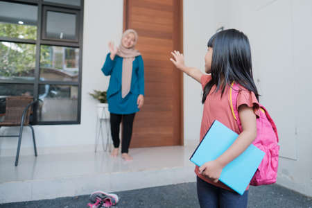happy kid wave goodbye to mother before going to school in the morningの写真素材