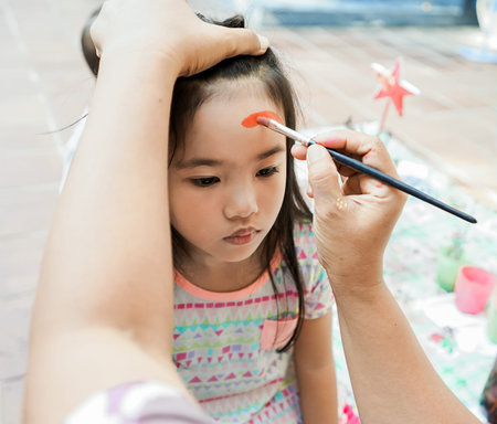 happy asian Child preschooler with face painting. Make up.