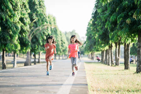 two Asian girl is jogging in the park in the morningの写真素材