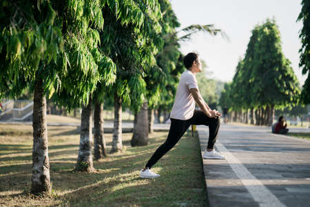 Handsome man stretching at the park - fitness conceptsの写真素材