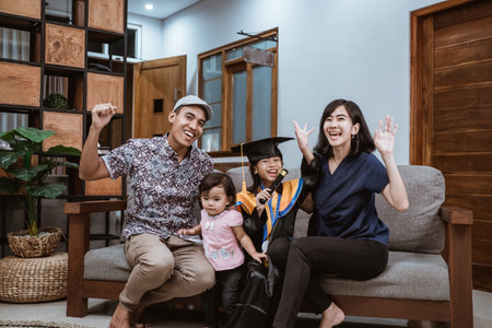 Kindergarten graduation. Happy asian family graduate at home. elementary school student at home...