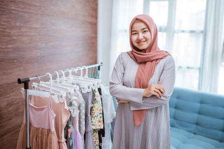 asian muslim small boutique shop smiling to cameraの写真素材