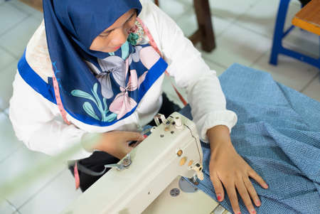 top view of hijab women tailor sewing fabricの写真素材