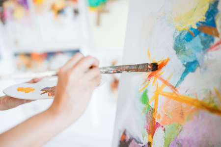 close up of female painters hand holding a paint brushの写真素材
