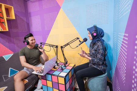 man and women discussing on live streaming during podcastの写真素材