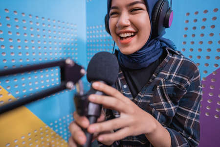 A vlogger girl is recording a podcast in studioの写真素材