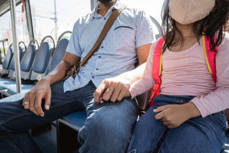 father taking his daughter to school by riding bus and hold handの写真素材