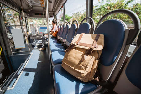 One lost bag or backpack lie on bus seatの写真素材
