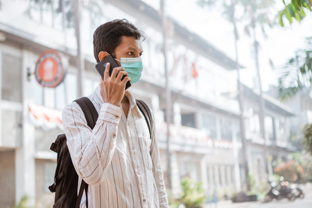 student wearing face mask before going to school or campus