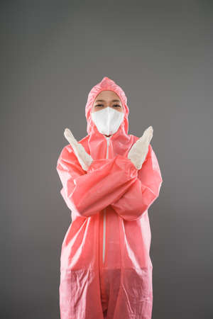Health worker wear personal protective equipment with two palms forward as a stop gestureの写真素材