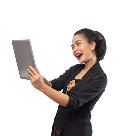 happy asian woman with kebaya using tablet computerの写真素材